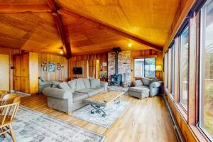 a living room with a couch and a table at Comstock Retreat in Sea Ranch +30 photos