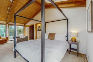 a bedroom with a canopy bed in a house at Brammer's Bluff in Sea Ranch