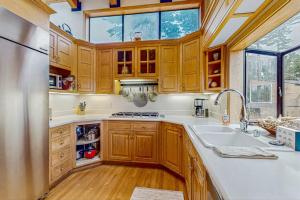 a kitchen with wooden cabinets and a sink at Brammer's Bluff in Sea Ranch +17 photos