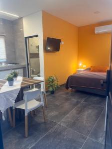 a bedroom with a bed and a table and a tableablish at Aqui es 6! in Banfield