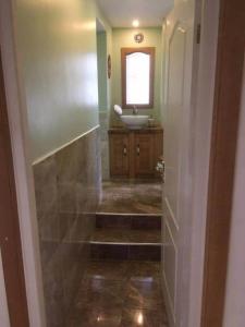 a bathroom with a sink and a toilet and a mirror at The Manor House, Killearn in Killearn