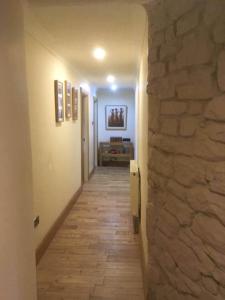a hallway with a stone wall and a hallway with a hallwayngthngthngthngth at The Manor House, Killearn in Killearn