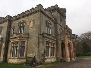 an old brick building with a gate in front of it at The Manor House, Killearn in Killearn +28 photos