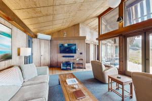 a living room with a couch and a table at Curtis-Moulton Retreat in Sea Ranch