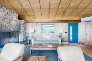 a living room with a couch and a fireplace at Curtis-Moulton Retreat in Sea Ranch +22 photos