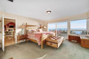 a bedroom with a bed and a large window at The Cliff House in Gualala