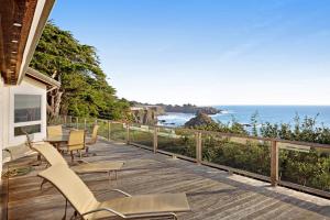 a porch with chairs and a view of the ocean at The Cliff House in Gualala