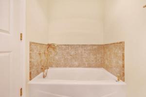 a bath tub in a bathroom with a tiled wall at The Cliff House in Gualala +32 photos