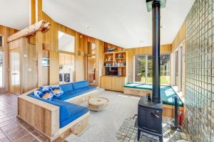 a living room with a blue couch and a stove at Toto House in Gualala