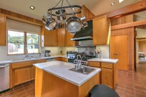 a kitchen with wooden cabinets and a sink at Toto House in Gualala