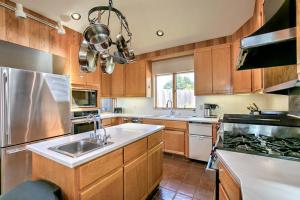 a large kitchen with wooden cabinets and a sink at Toto House in Gualala +15 photos