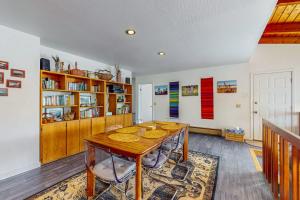 a dining room with a table and a book shelf at The Bobcat House in Sea Ranch