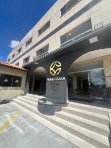 a building with a sign on the front of it at Hotel Prime Ceaka in Caruaru +18 photos