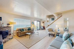 a living room with a couch and a fireplace at The Lookout Point in Gualala +17 photos