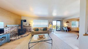 a living room with a couch and a fireplace at The Lookout Point in Gualala