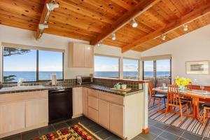 a kitchen and dining room with a view of the ocean at Casa Pelo Mar in Sea Ranch