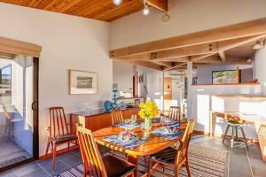 a dining room with a wooden table and chairs at Casa Pelo Mar in Sea Ranch