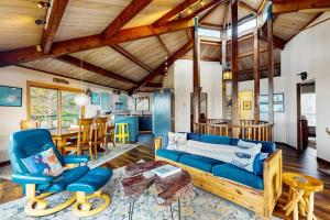 a living room with a blue couch and a table at Seas the Day in Sea Ranch +29 photos