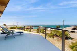 a bench sitting on a balcony with a view of the ocean at Gualala Harmony House in Gualala