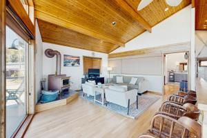 a living room with a couch and a tv at Gualala Harmony House in Gualala