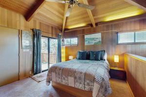 a bedroom with a bed and a ceiling fan at Nature's Paradise in Gualala