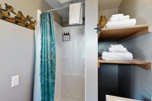 a bathroom with a shower curtain and some towels at Nature's Paradise in Gualala