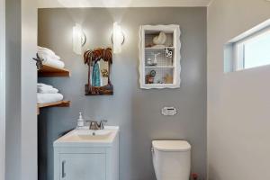 a bathroom with a white toilet and a sink at Nature's Paradise in Gualala