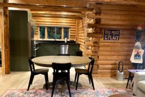 a kitchen with a table and chairs in a room at Cabin Fever in Gualala