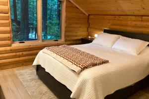 a bedroom with a bed in a log cabin at Cabin Fever in Gualala