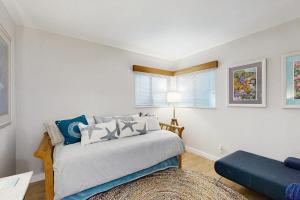 a bedroom with a bed and a blue couch at Sea Trees in Sea Ranch
