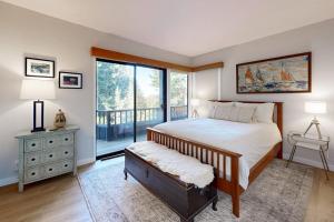 a bedroom with a bed and a large window at Sea Trees in Sea Ranch