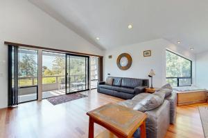 a living room with a couch and a table at Footloose in Sea Ranch