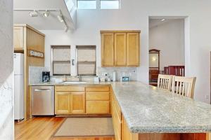 a kitchen with wooden cabinets and a counter top at Footloose in Sea Ranch +14 photos