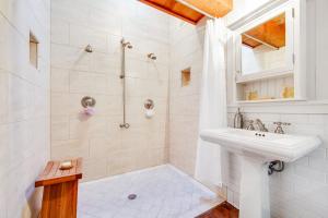 a white bathroom with a shower and a sink at Shangri-lala in Gualala
