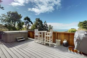 a deck with two chairs and a hot tub at Rainbow's End in Valley Crossing