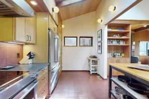 a kitchen with wooden cabinets and a counter top at Rainbow's End in Valley Crossing +21 photos