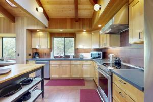a large kitchen with wooden cabinets and a counter top at Rainbow's End in Valley Crossing