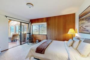a bedroom with a large bed and a balcony at Albatross Reach in Sea Ranch