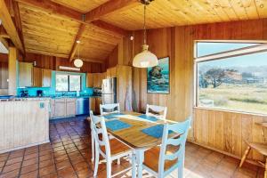 a kitchen and dining room with a table and chairs at Albatross Reach in Sea Ranch