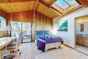 a bedroom with a bed and a desk and a window at Albatross Reach in Sea Ranch +14 photos