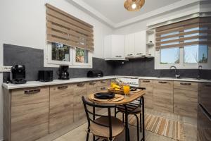 a kitchen with a table and some chairs in it at Destinys Village I in Zakynthos