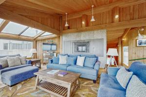 a living room with blue couches and a table at Compass Rose in Sea Ranch