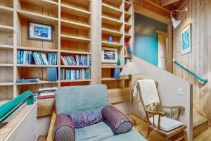 a room with a chair and a book shelf at Compass Rose in Sea Ranch