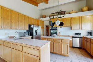 a large kitchen with wooden cabinets and a kitchen island at Whale Tales in Gualala