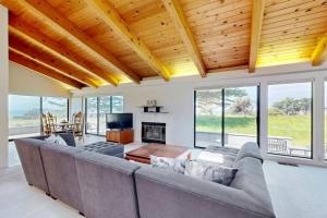 a living room with a couch and a fireplace at Whale Tales in Gualala