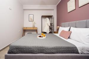 a bedroom with a bed with a tray of food on it at Destinys Village I in Zakynthos +13 photos