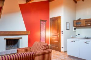 a living room with two chairs and a fireplace at La Corte dell'Anatra in Cortile