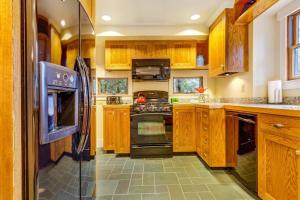 a large kitchen with wooden cabinets and appliances at Spyglass View in Sea Ranch