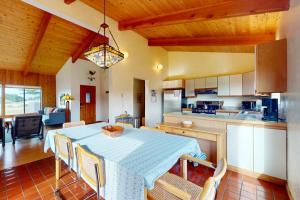 a kitchen and dining room with a table and chairs at Whispering Wave in Gualala +35 photos