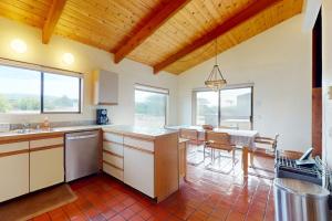 a kitchen with a table and a dining room at Whispering Wave in Gualala